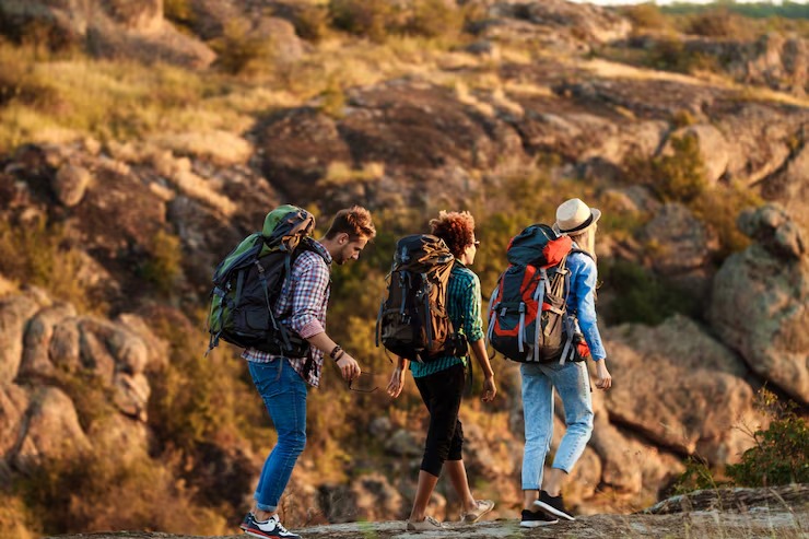 Young travelers hiking through a canyon landscape
